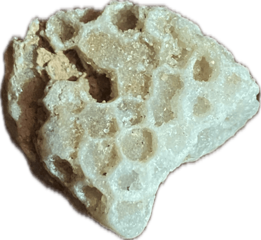 White rock with hexagonal formations filled with tiny crystals